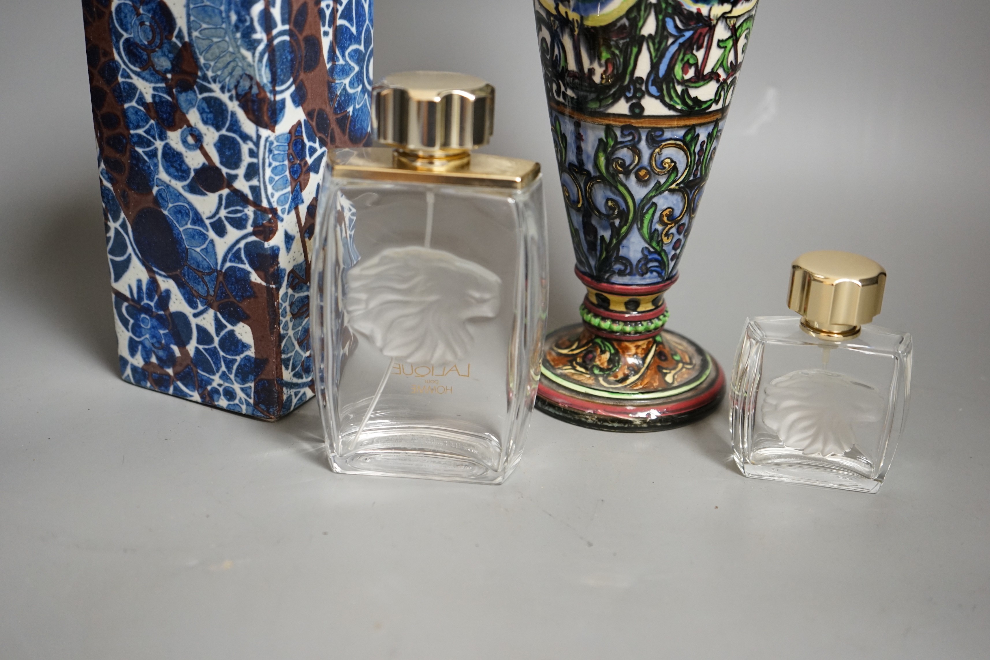 A Royal Copenhagen faience vase and a grotesque style bottle vase and two Lalique pour Homme perfume bottles, faience vase 23cms high